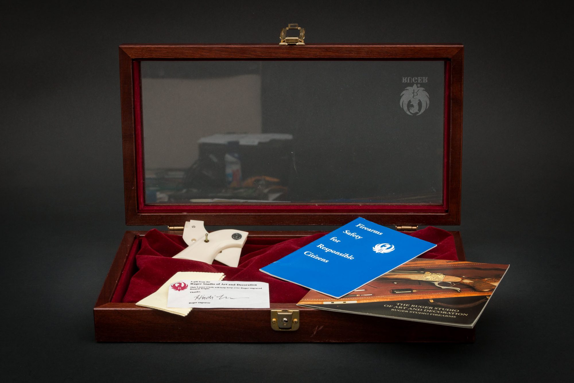 Display case and documents for Stainless Ruger Vaquero engraved by Heidi Roos